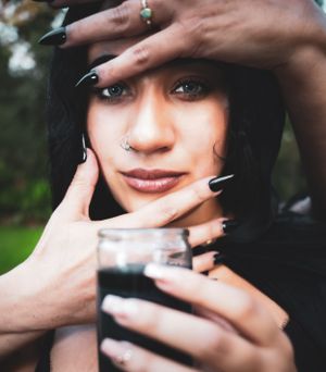 Close-up portrait series with black nail polish and artistic hand placements.