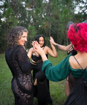 Choreographed dance sequence showing flowing movements between performers in gothic attire.