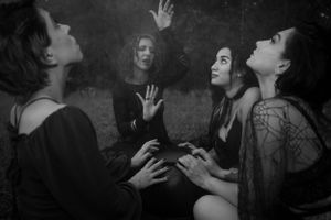 Dramatic black and white photographs capturing expressive dance-like movements outdoors.
