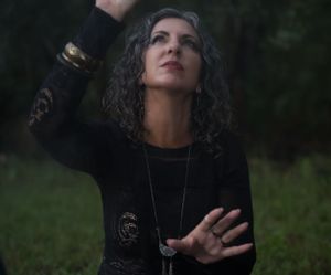 Atmospheric portrait series showing figures in dark clothing against a natural backdrop.