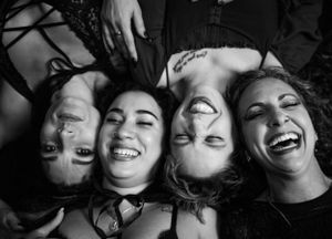 Black and white overhead shot showing expressions of joy and laughter.
