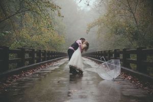 Bride and Groom dance in the rain on a bridge in Salida, Colorado.