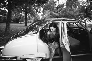 Bride steps out of car on rainy day for her wedding in Salida, Colorado.