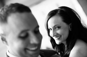 Wedding day couple share a laugh in this black and white photograph.