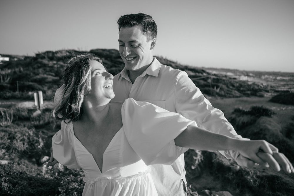 A couple shares intimate moments during a black and white outdoor photo session.