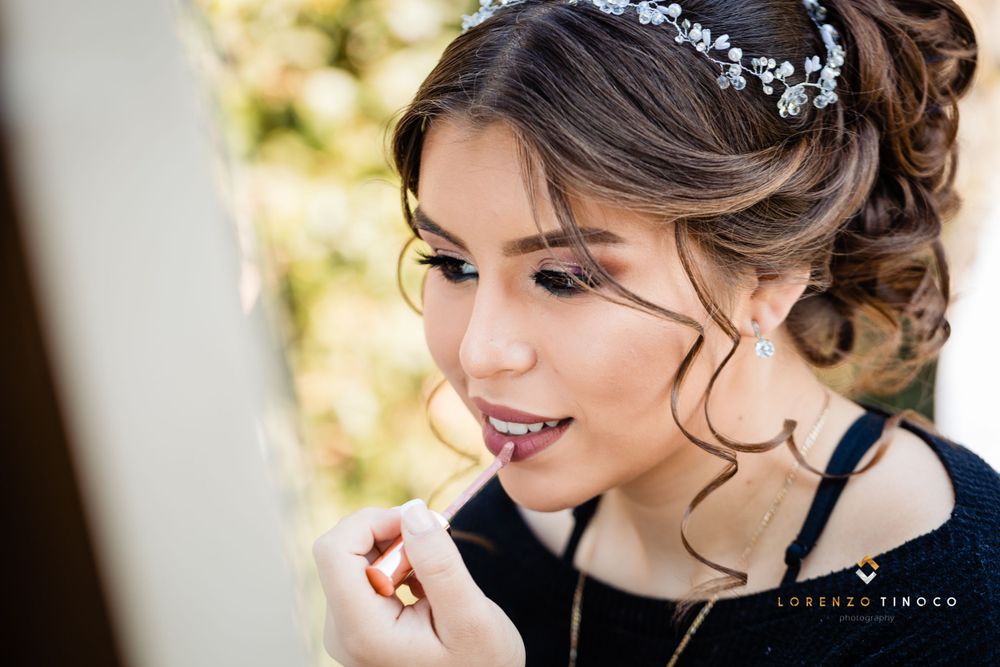 Side profile of elegant evening makeup with soft romantic curls and hair accessories.
