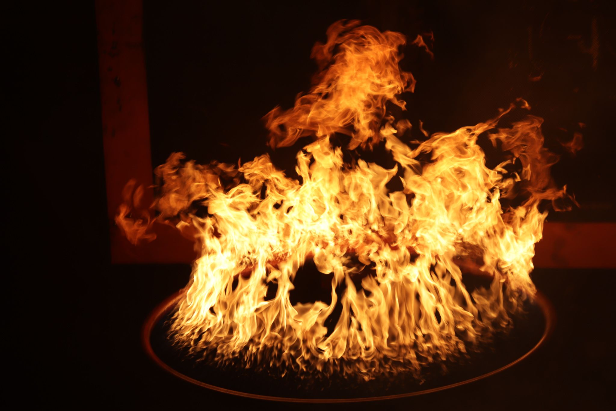 Ring of intense flames creating a dramatic circular fire effect on dark background.