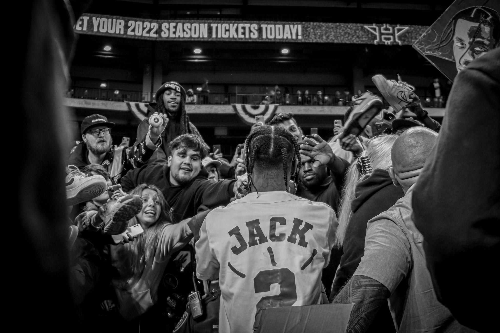 Fans celebrate at sporting event with person wearing jersey number 2.