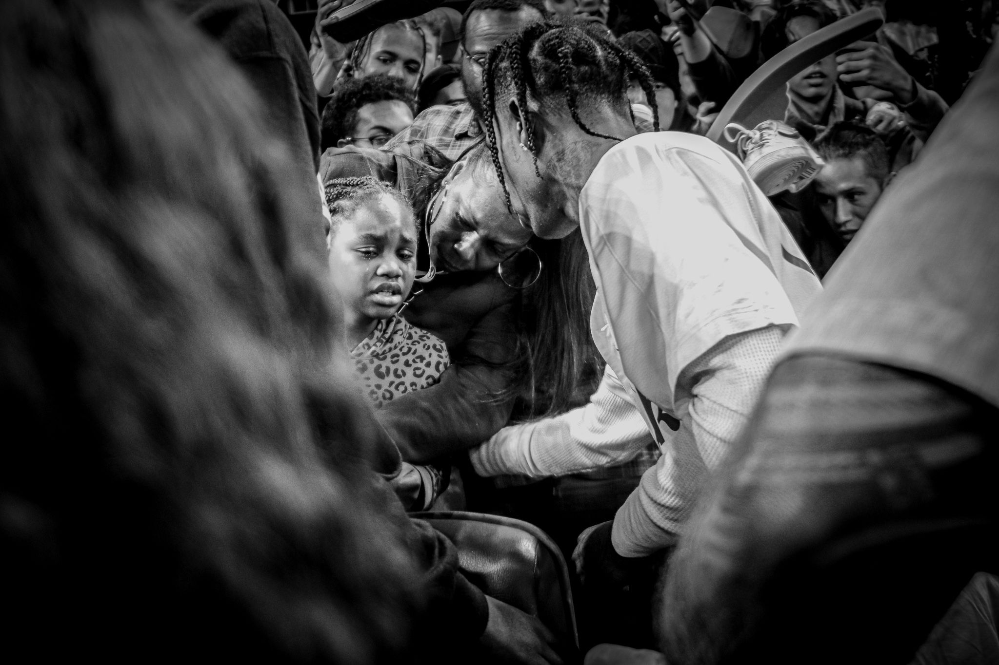 Black and white photo of crowded concert audience interacting with performers.