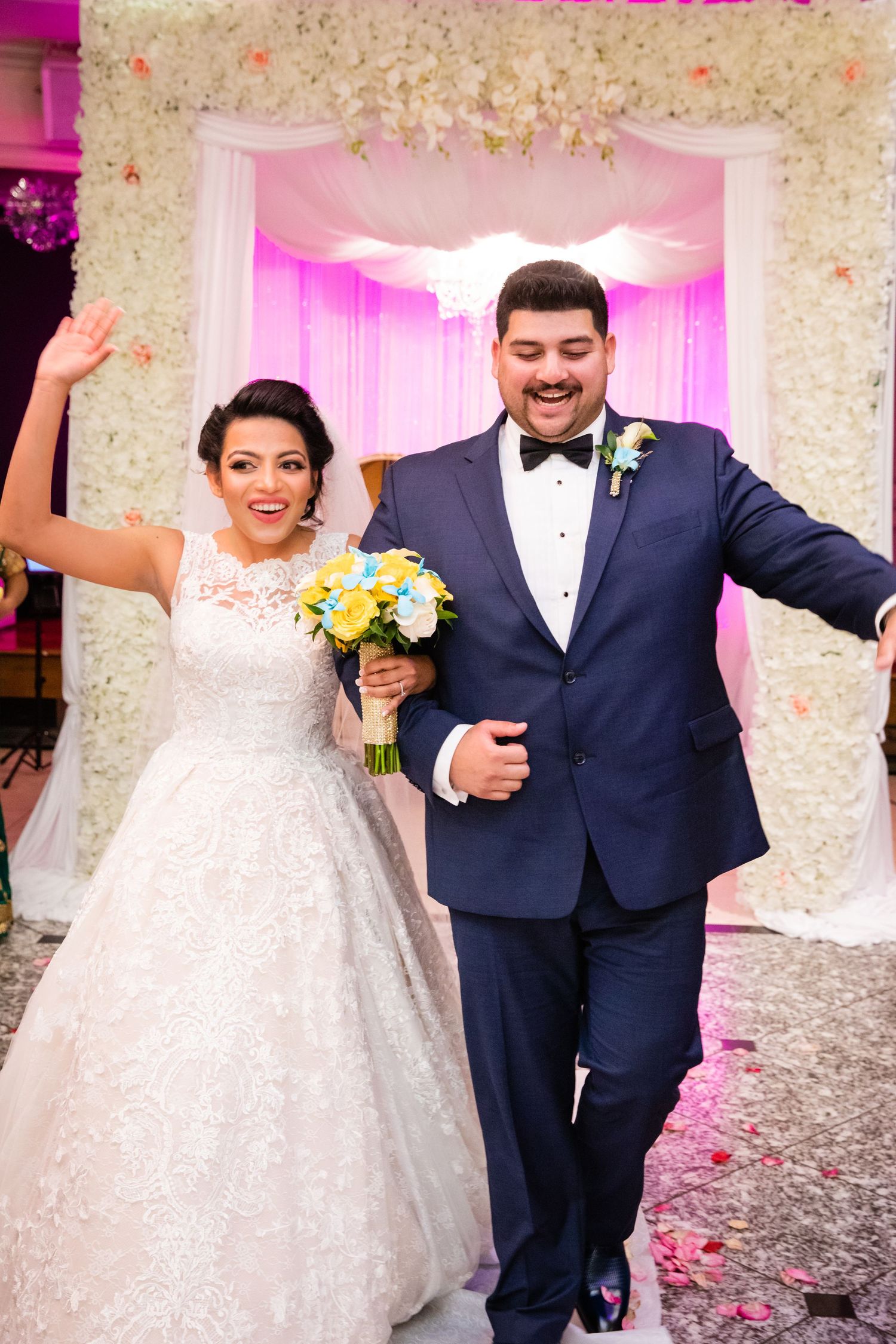 Bride and Groom holds hands and walk down the aisle together by Long Island Photographer Placid Media.