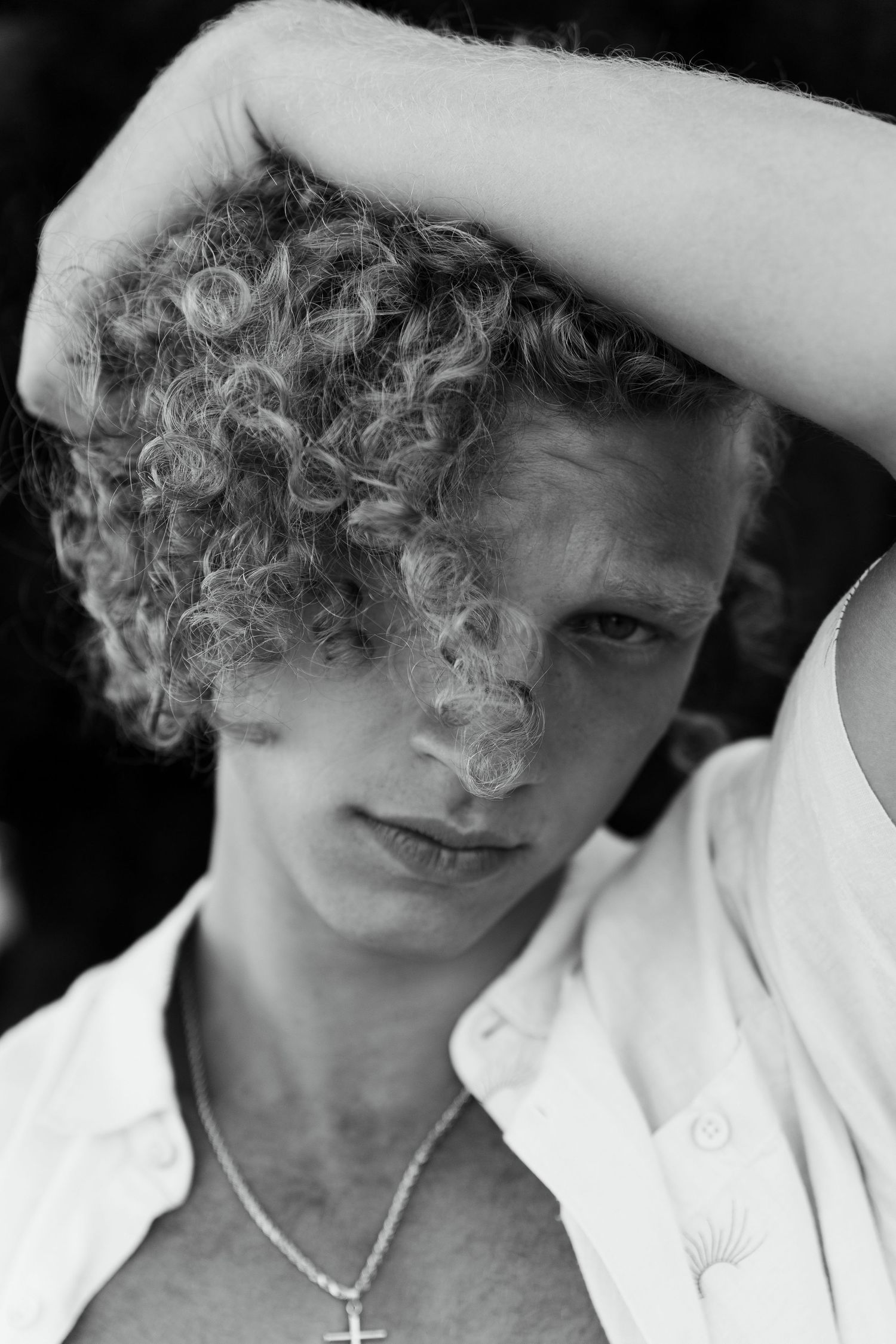 Black and white portrait of curly blonde male editorial model, San Clemente beach fashion editorial
