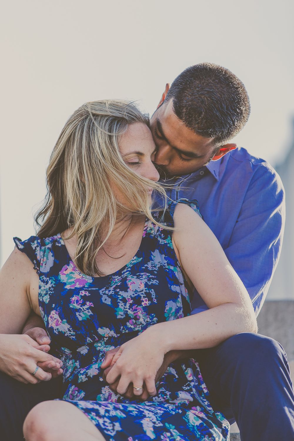 Intimate portrait of a couple in casual attire sharing a tender moment together.