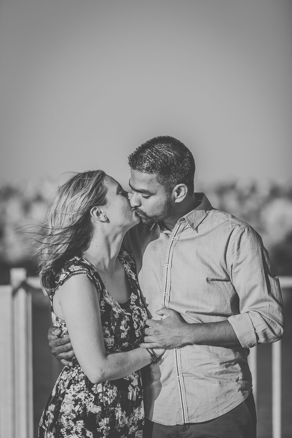 Black and white portrait of a couple in a romantic embrace.