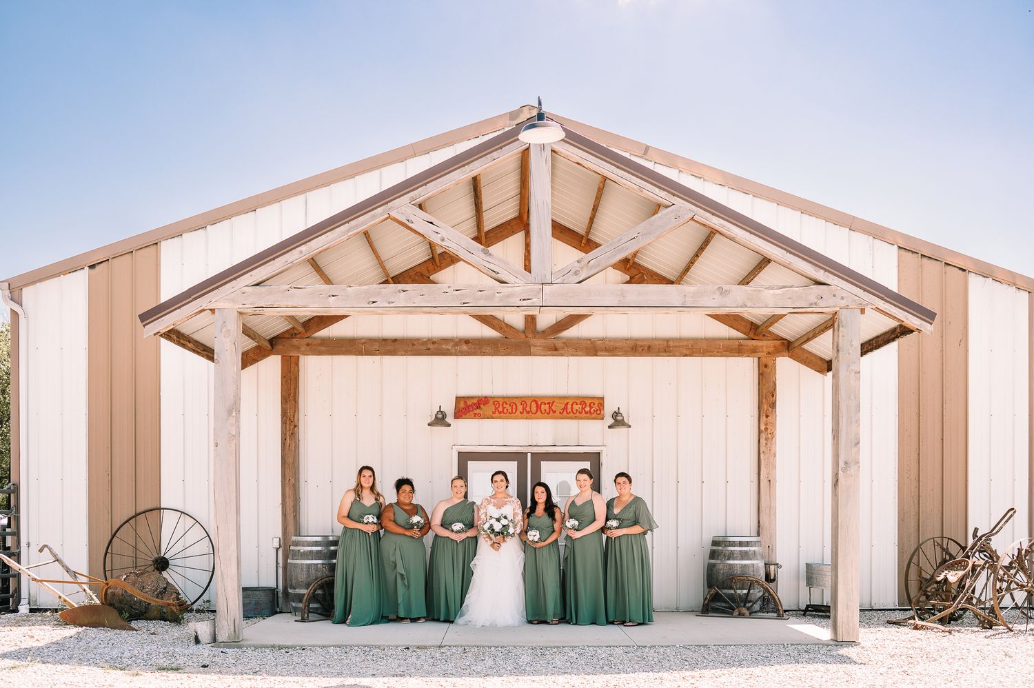 Bridesmaids standing in front of barn venue