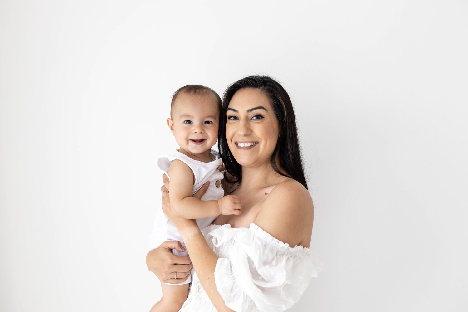 Blooming Desert Photography owner Angelique with son in minimalist photography studio.