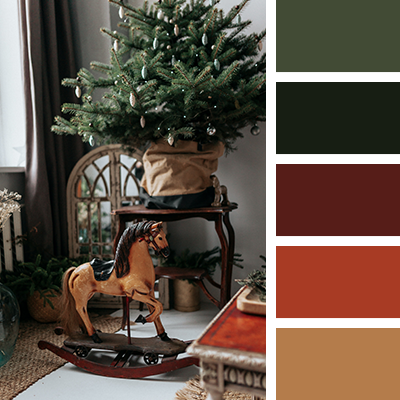 Christmas decor color palette featuring vintage rocking horse and tree with deep greens and burgundy tones.