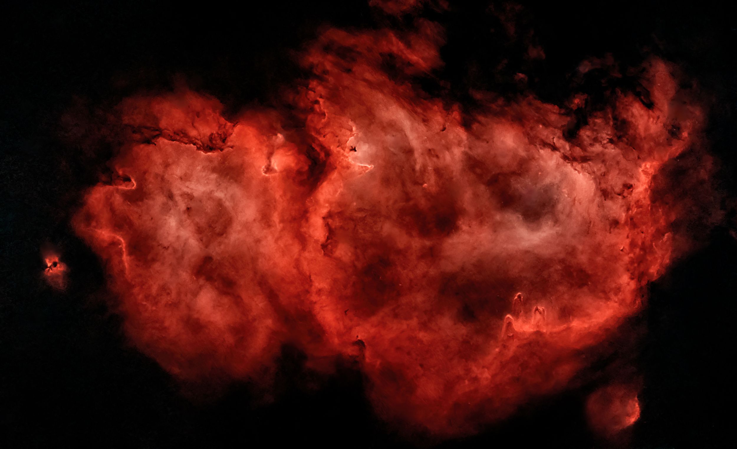 The Heart Nebula illuminates the cosmos with its distinctive red glow and complex gas structures.