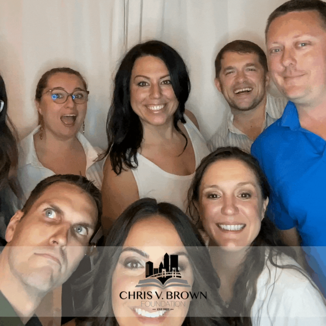 large group of people in front of photo booth making silly faces