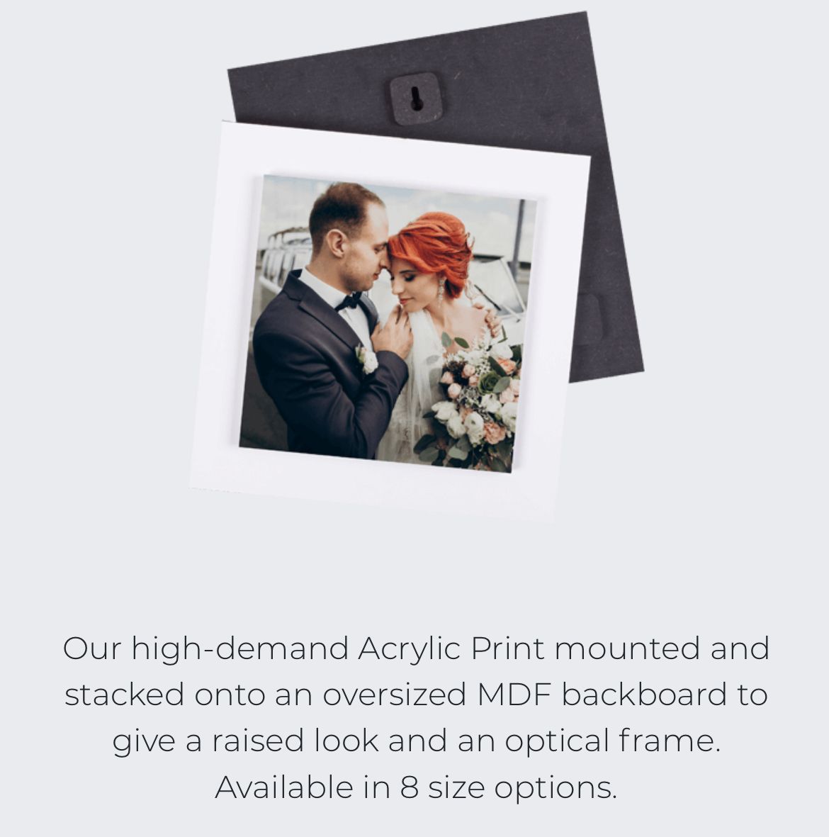 Wedding photograph mounted on black MDF backboard showing intimate moment.