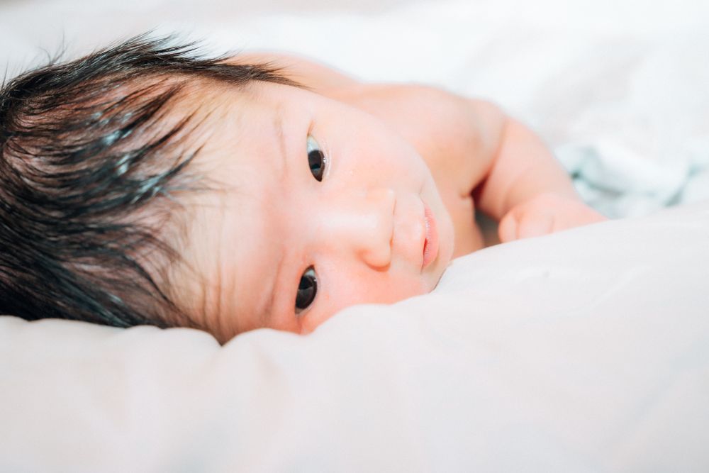 New born baby looking at the camera