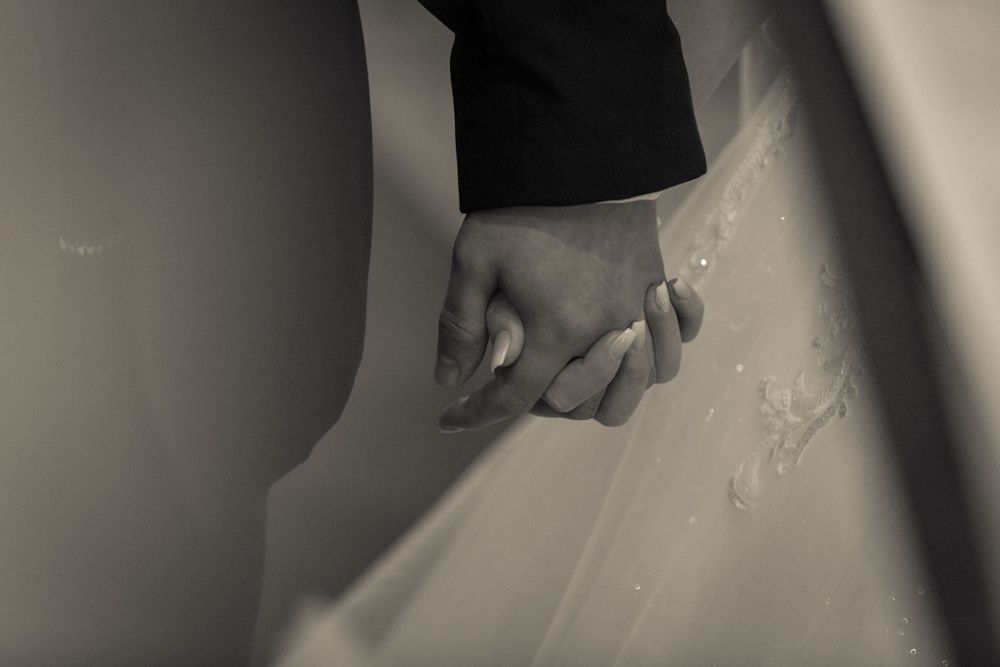 bride and groom holding hands during the ceremony