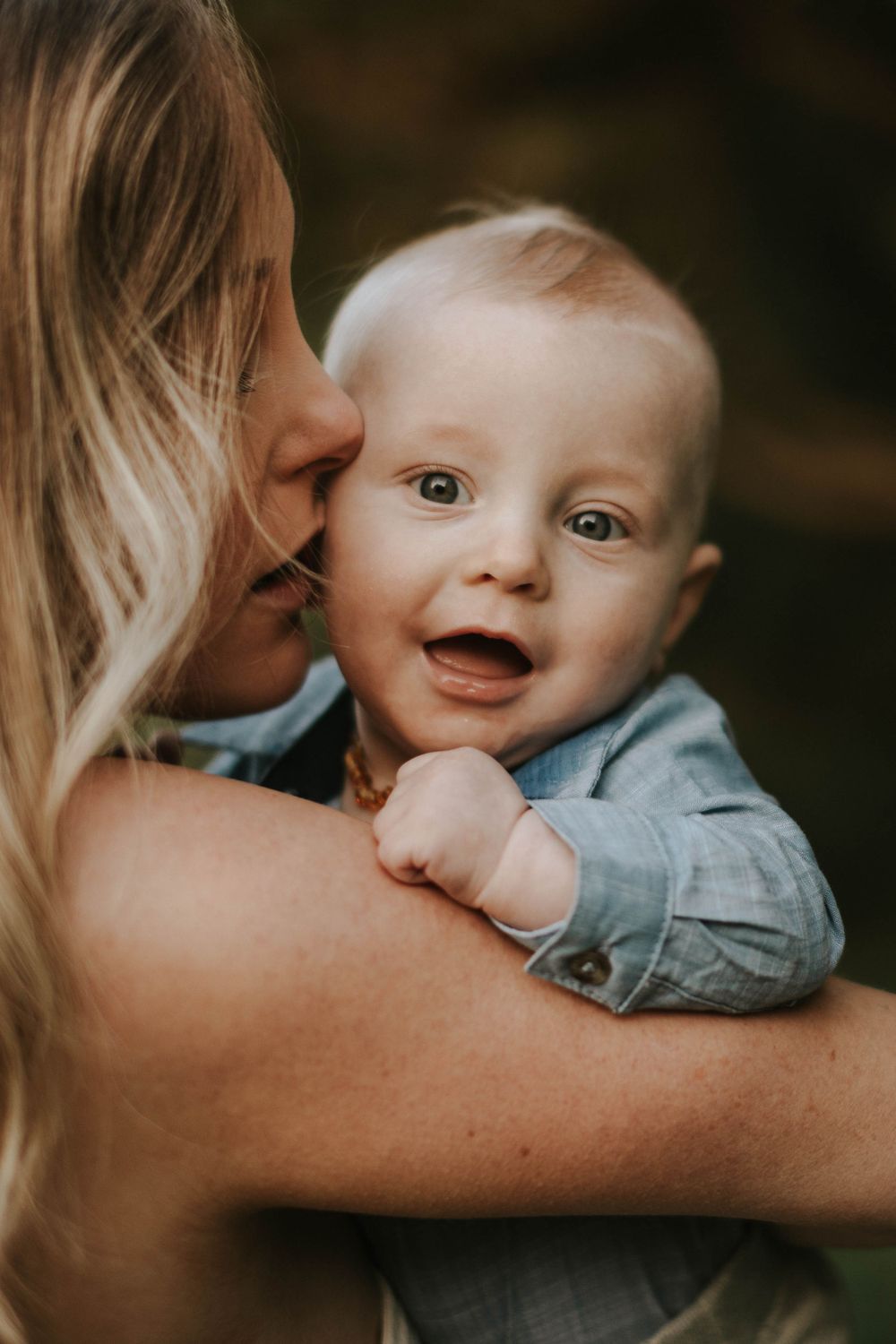 An intimate moment captured between parent and baby with soft natural lighting.