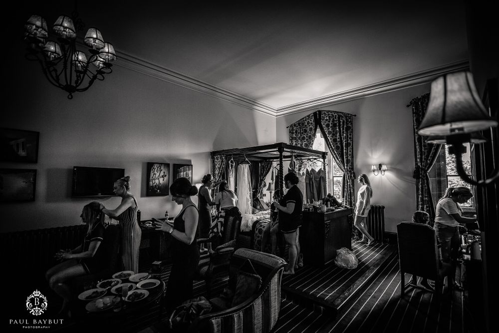 Black and white photo of a hotel room interior with vintage lighting and furniture.