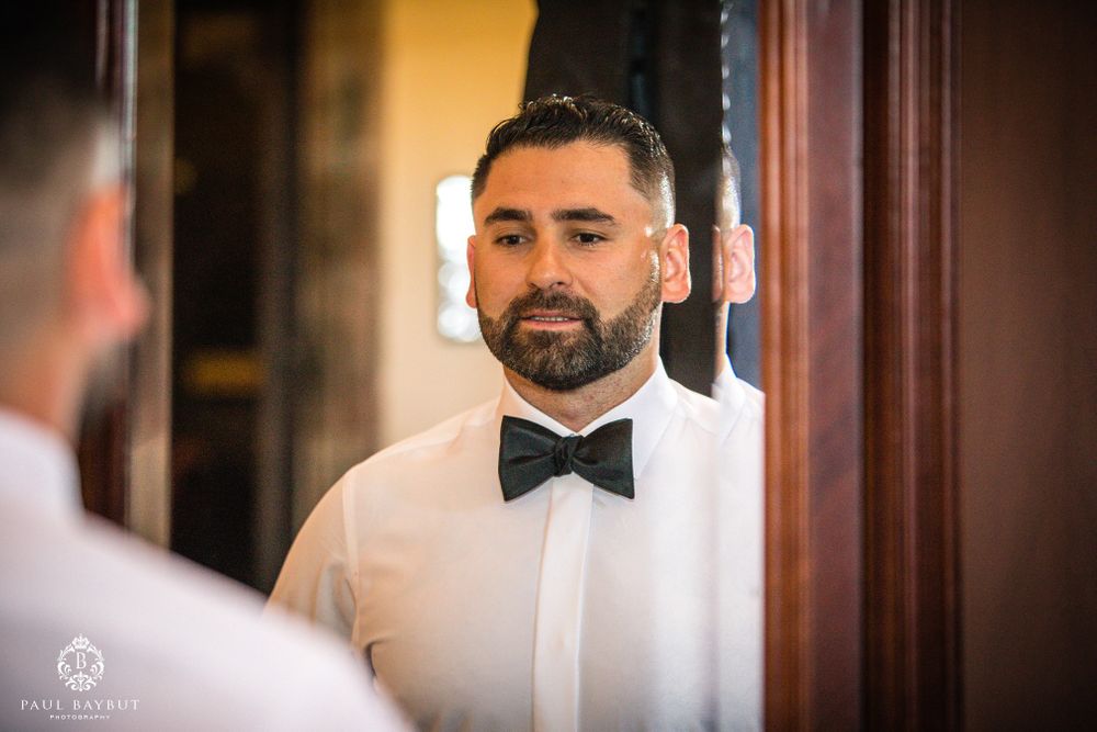 Reflection of formal attire preparation in mirror.