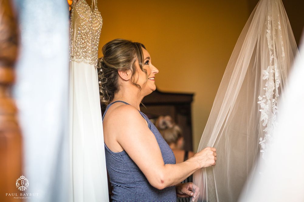 Wedding preparations with dress and veil being arranged.