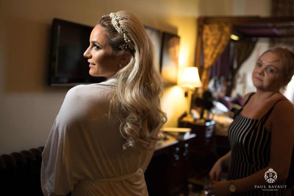 Side profile view in a warmly lit room with vintage-style decor and wall art.