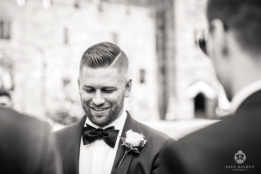 Black and white candid moment during wedding celebrations.