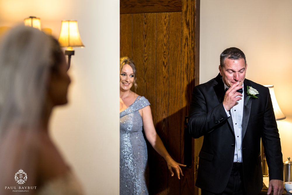 Emotional reactions during a wedding first look moment in an elegant interior setting.