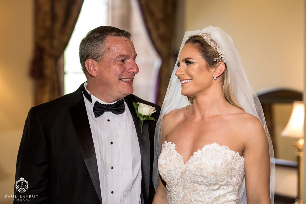 A sweet moment shared between wedding couple during formal portraits.