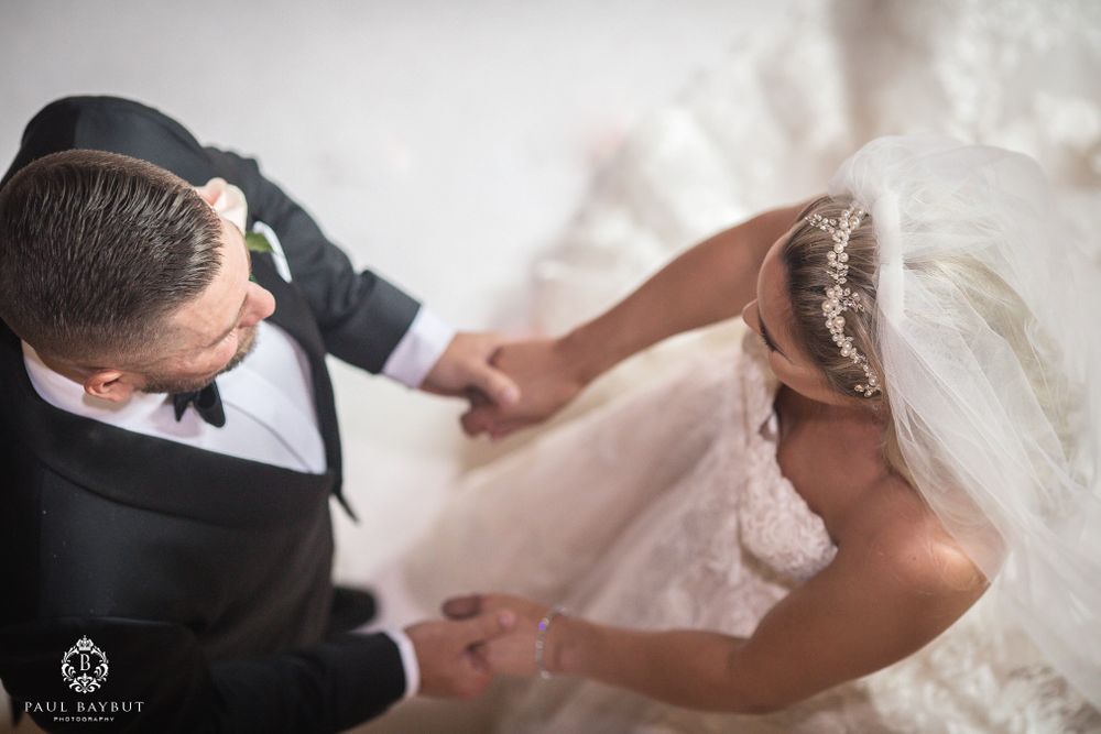 A bride and groom share an intimate moment during their first dance at an elegant wedding reception.