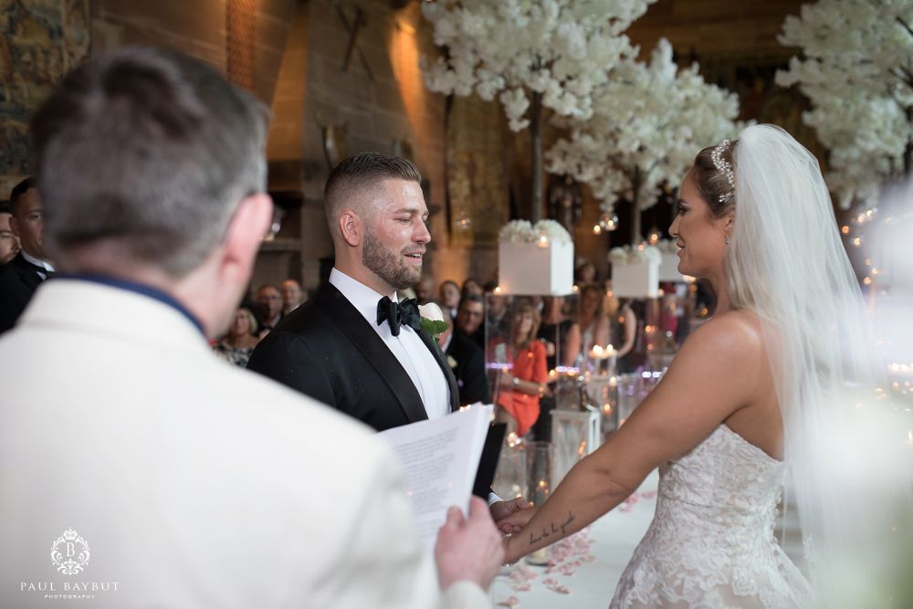 A tender moment during wedding vows with soft lighting and romantic atmosphere.