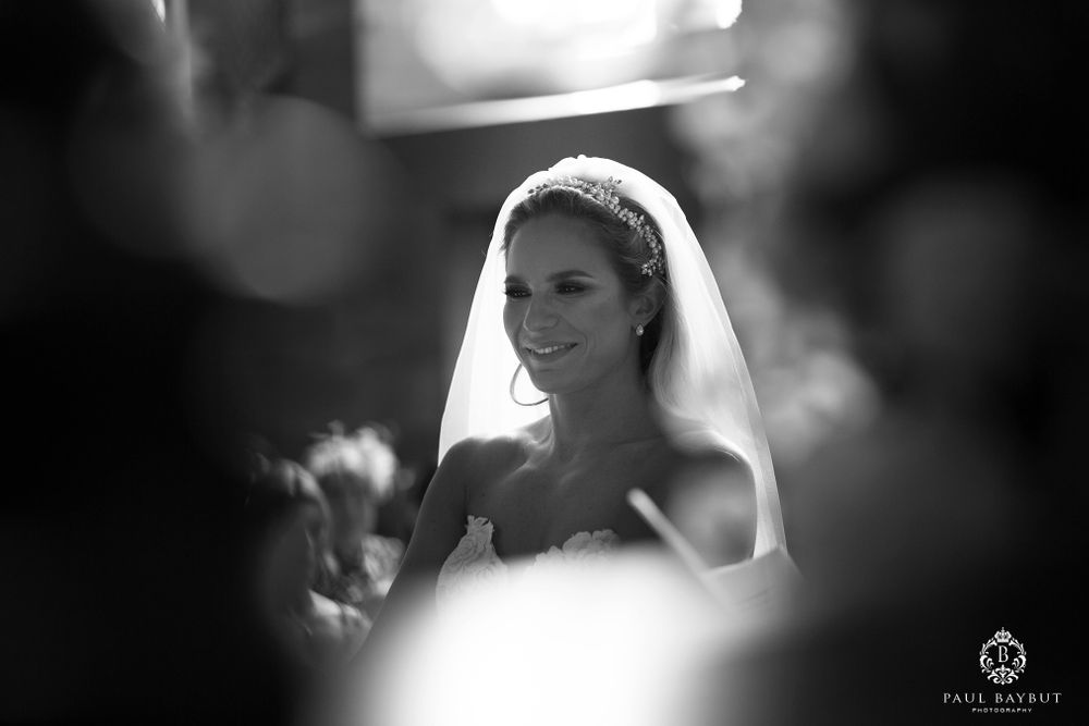 Artistic black and white bridal portrait through soft focus with veil detail.