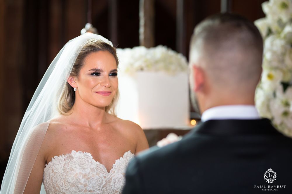 Intimate wedding ceremony moment with white strapless gown and elegant veil.