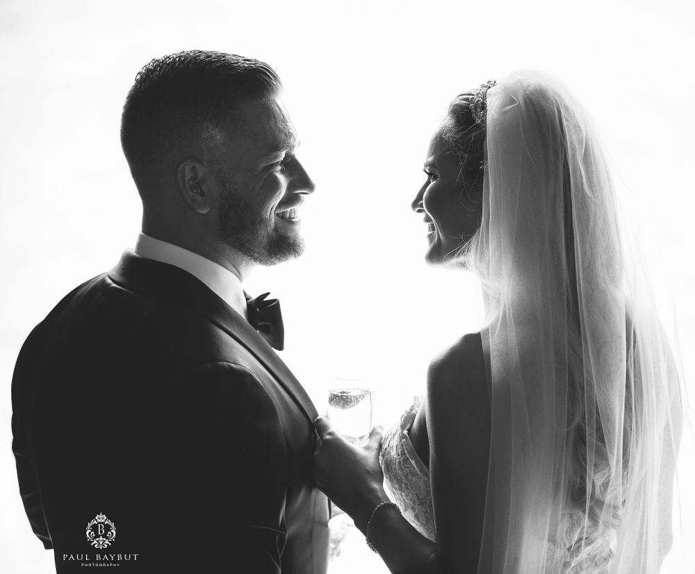 Artistic black and white silhouette portrait of newlyweds in intimate moment.