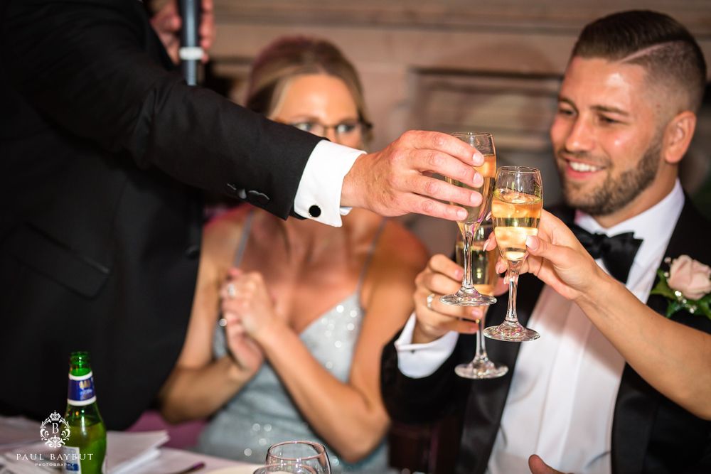 A celebratory champagne toast during an elegant wedding reception.