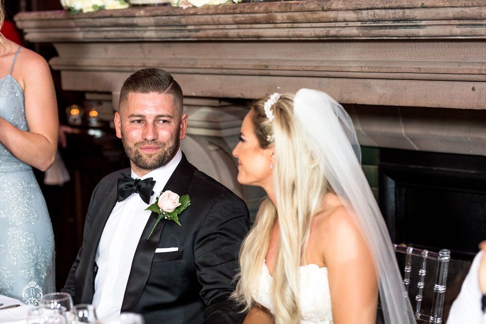 Intimate moment captured during wedding reception speeches and toasts.