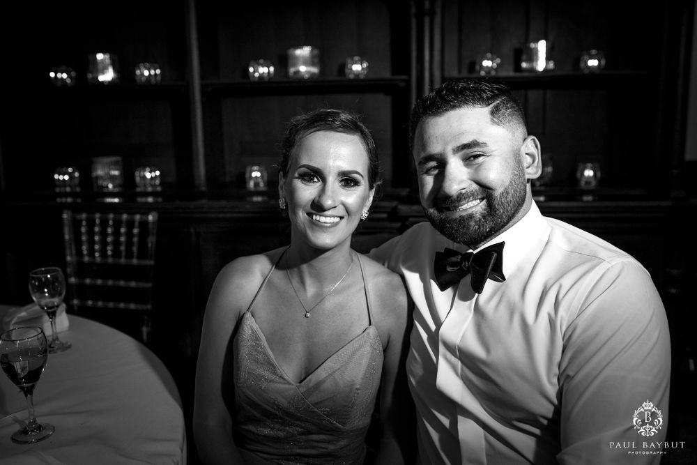 Black and white portrait of a couple at a formal wedding celebration.