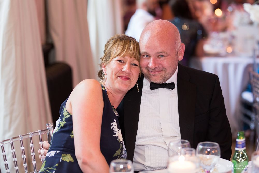 Guests enjoying a formal dinner reception at an elegant venue.