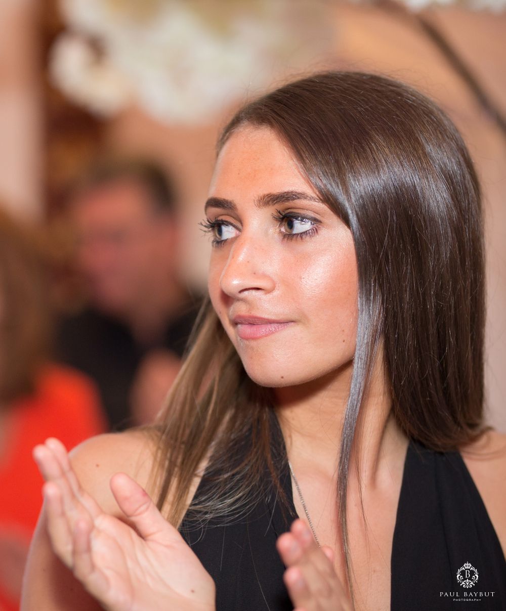 Wedding guest clapping during reception celebration.