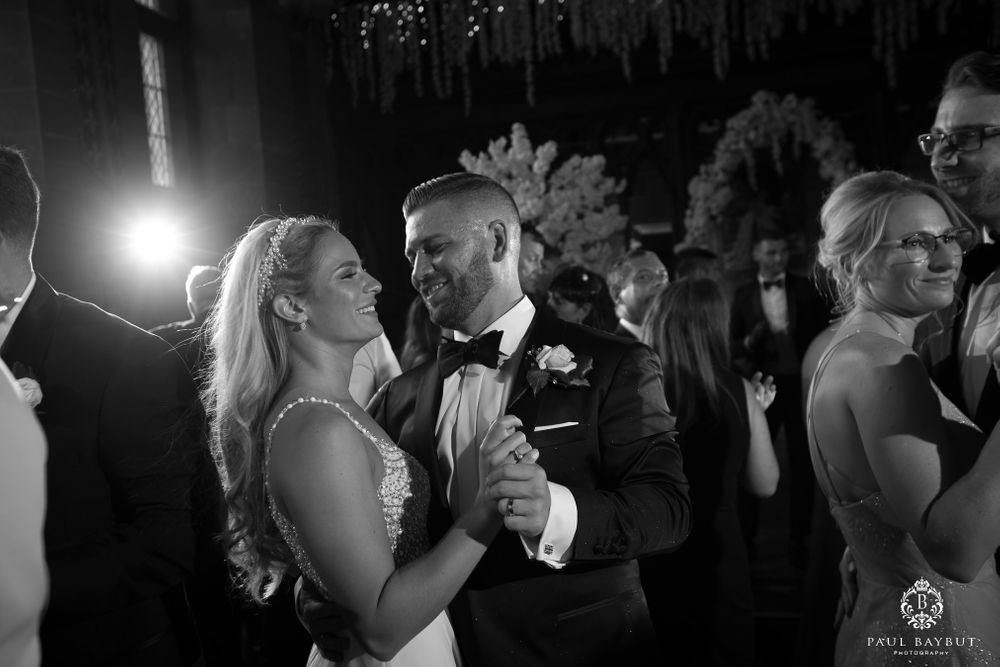 Couples slow dance together during an intimate wedding reception moment.