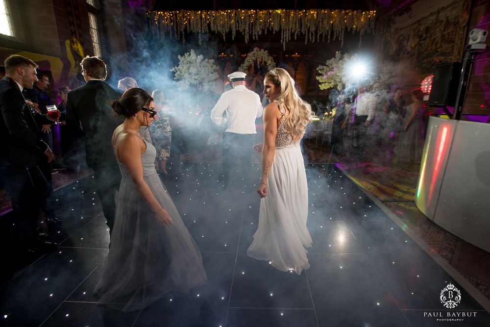 Wedding reception dance floor filled with atmospheric fog and elegant party lighting effects.