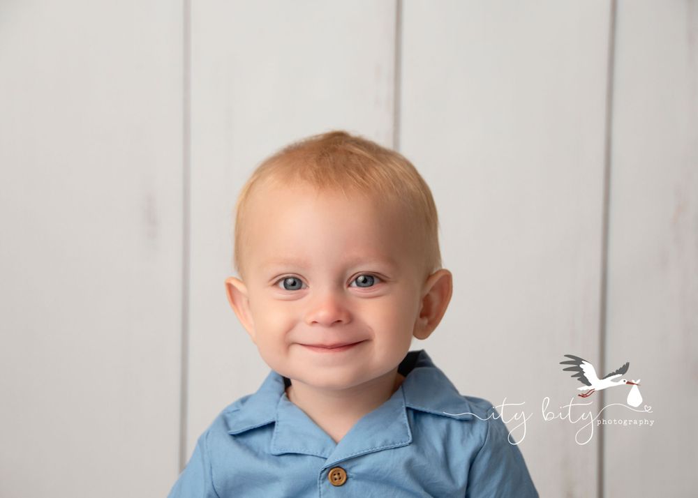 The cutest smile on One Year Liam during his cake smash session at Ity Bity Photography in Avon Ohio