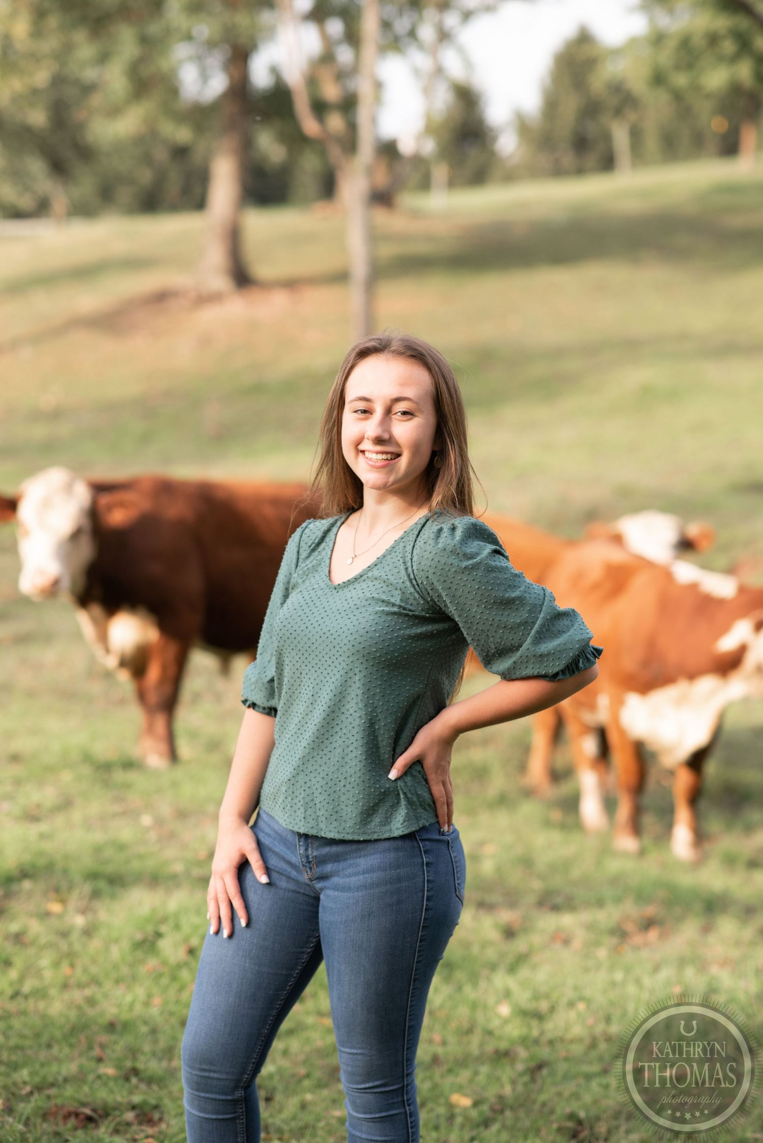 Rural portrait with Hereford cattle grazing in background on rolling hills.