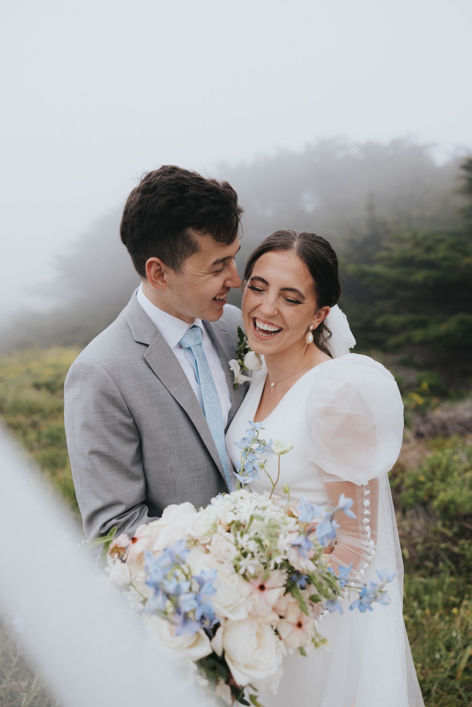 A bride and groom smile during their destination wedding near Big Sur CA as captured by their wedding photographer