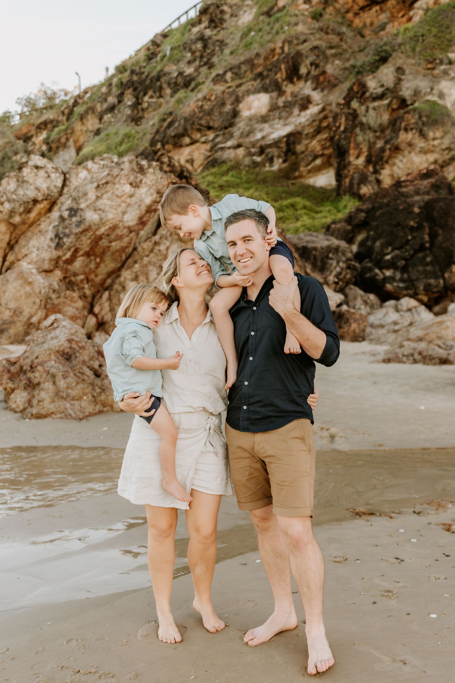 family of four smiling for a photo