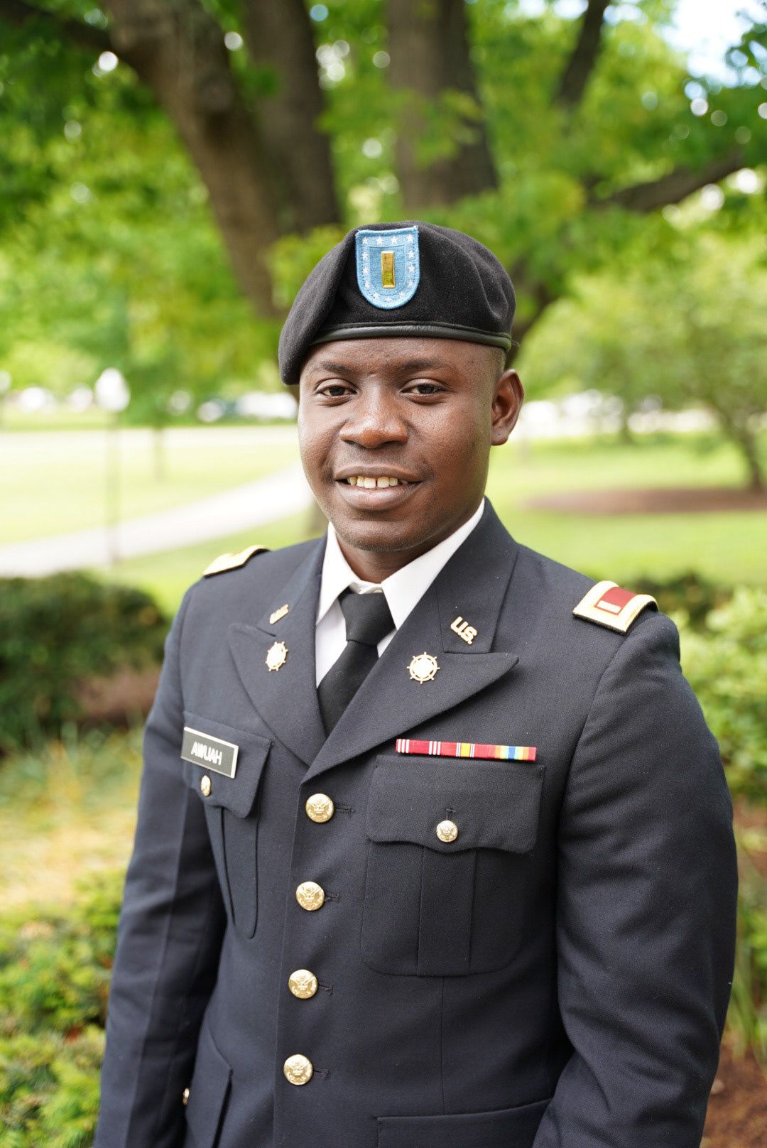 Military service member in dress uniform poses for professional outdoor portrait series.